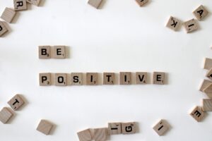 Be positive spelled out with scrabble pieces