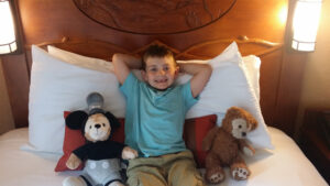 Little boy relaxing on a bed on cruise ship in gulf of mexico